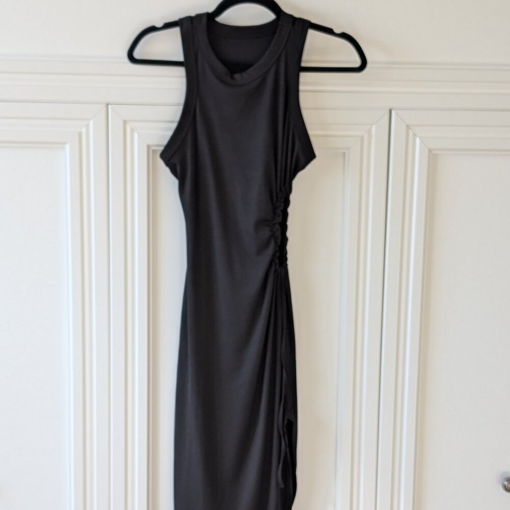 Black bodycon dress with adjustable tie rib cut out. 12-in slit